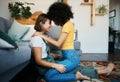 Lgbtq, couple and love with hug on a living room floor in new home with smile of lesbian women. Gay marriage, happy and