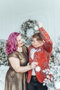 LGBTQ lesbian couple celebrating Christmas or New Year winter holiday together. Gay female lady with butch partner decorating Royalty Free Stock Photo