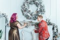 LGBTQ lesbian couple celebrating Christmas or New Year winter holiday together. Gay female lady with butch partner decorating Royalty Free Stock Photo