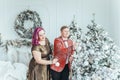 LGBTQ lesbian couple celebrating Christmas or New Year winter holiday together. Gay female lady with butch partner decorating Royalty Free Stock Photo