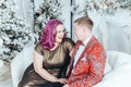 LGBTQ lesbian couple celebrating Christmas or New Year winter holiday together. Gay female lady with butch partner hugging