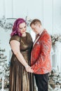 LGBTQ lesbian couple celebrating Christmas or New Year winter holiday together. Gay female lady with butch partner