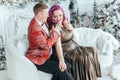 LGBTQ lesbian couple celebrating Christmas or New Year winter holiday together. Gay female lady with butch partner hugging