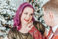 LGBTQ lesbian couple celebrating Christmas or New Year winter holiday together. Gay female lady with butch partner