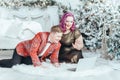 LGBTQ lesbian homosexual couple celebrating Christmas or New Year. Gay young lady female woman with butch partner calling friends