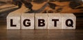 LGBTQ letters wooden cubes letters, on wooden background