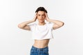 Lgbtq and pride concept. Beautiful and confident gay man wearing crop top, touching face and looking sassy at camera