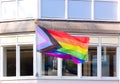 LGBTQ rainbow flag is flown on the facade of the building. City street. Equal rights. Amsterdam, Netherlands, Europe