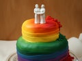 LGBTQ rainbow wedding cake with two woman on top. Lesbian couple wedding cake Royalty Free Stock Photo