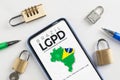 LGPD brazilian data protection law concept: smartphone sorrounded by padlocks with an imaginary page showing a link to read the