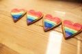 LGTB hearts cookies on a wooden table. Rainbow heart cookie. Heart lgbt+ sign rainbow color stripe. Symbolic free love concept Royalty Free Stock Photo