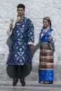 Unidentified Tibetan couple in front of Jokhang temple. The Buddhist Temple in Barkhor Square , Lhasa Tibet