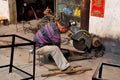 Li 'An, China: Man Cutting Pipe