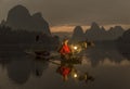 Li River - Xingping, China. January 2016 - An old fisherman fishing with his cormorants.
