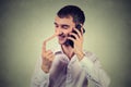 Liar customer service representative. Happy man with long nose talking on mobile phone Royalty Free Stock Photo