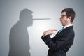 Liar has shadow with long nose. Conscience concept. Royalty Free Stock Photo
