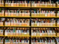 Libary rack with many small books sorted in small folder Royalty Free Stock Photo