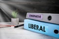 LIBERAL and CONSERVATIVE. Two binders on desk in the office Royalty Free Stock Photo