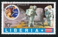 Apollo badge and astronauts collecting yellow lunar dust
