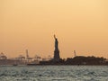 Liberty island, New York City - Statue of Liberty on Hudson river during cruise sunset at dusk