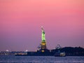 Liberty island, New York City - Statue of Liberty on Hudson river during cruise sunset at dusk