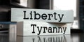 Liberty, tyranny - words on wooden blocks