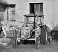 Libesice, Czech republic - May 19, 2018: wreck of old tractor in front of house in Libesice village during spring sunrise with bla