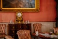 Libochovice, Bohemia, Czech Republic, 19 September 2021: Castle interior with baroque wooden furniture, gold plated antique clock