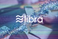 Libra cryptocurrency sign. Business person, trader, investor, analyst using mobile phone app analytics to analyze cryptocurrency