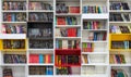 Library with bookcases. Many different books on the shelves. Large selection of books in a bookcase. Blur background.