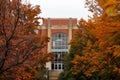 library building viewed between autumncolored trees Royalty Free Stock Photo