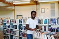 Library employee pushing book cart