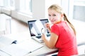 In the library - pretty, female student with books and laptop