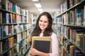 In the library - pretty female student with books working in a h