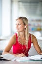 Pretty female student with books working in a high school library Royalty Free Stock Photo