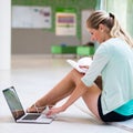 In the library - pretty female student with books