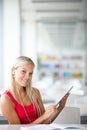 Pretty female student with books working in a high school library Royalty Free Stock Photo