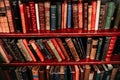 Library shelf filled with an array of colorful books.