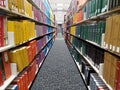 A library shelve of books grouped by color