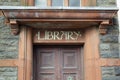 Library sign on stone lintel above door