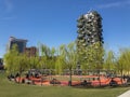 Library of Trees, relaxation area with benches and swings. Weeping willows. Vertical forest seen from the new park in the heart of Royalty Free Stock Photo