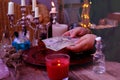 Librate with money, female hands of psychic doing witchcraft passes with dollars, esoteric Oracle performs ritual of removing