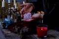 Librate with pendulum, healing or oracle foretelling, magic session, Female Fortuneteller or esoteric Oracle performs spell,