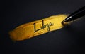 Libya Handwriting Text on Golden Paint Brush Stroke