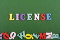 LICENSE word on green background composed from colorful abc alphabet block wooden letters, copy space for ad text. Learning