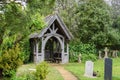 Lichgate with headstones in rural english cemetery