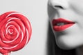 young womans mouth and a red lollipop Royalty Free Stock Photo