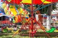 LIDA, BELARUS - JULY 10, 2021: Bright colorful children carousel in the amusement park in summer.