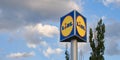Lidl logo sign on tall pole and clouds, with copy space. Lidl is a German international discount retailer chain in Europe.