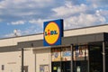 Lidl market store logo sign and clouds. Lidl is a German international discount retailer chain with stores across Europe.